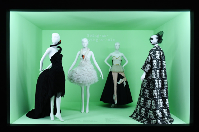 Photo of a green box gallery with four mannequins wearing black and white costumes