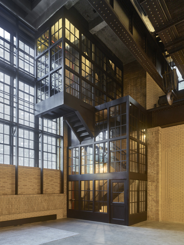 Photo of a building interior with industrial finishes and a large stair