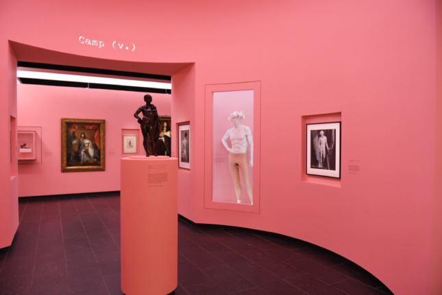 A pink room with several sculptures in it