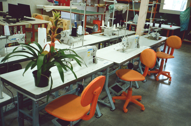 Photo of orange rolling chairs at folding tables