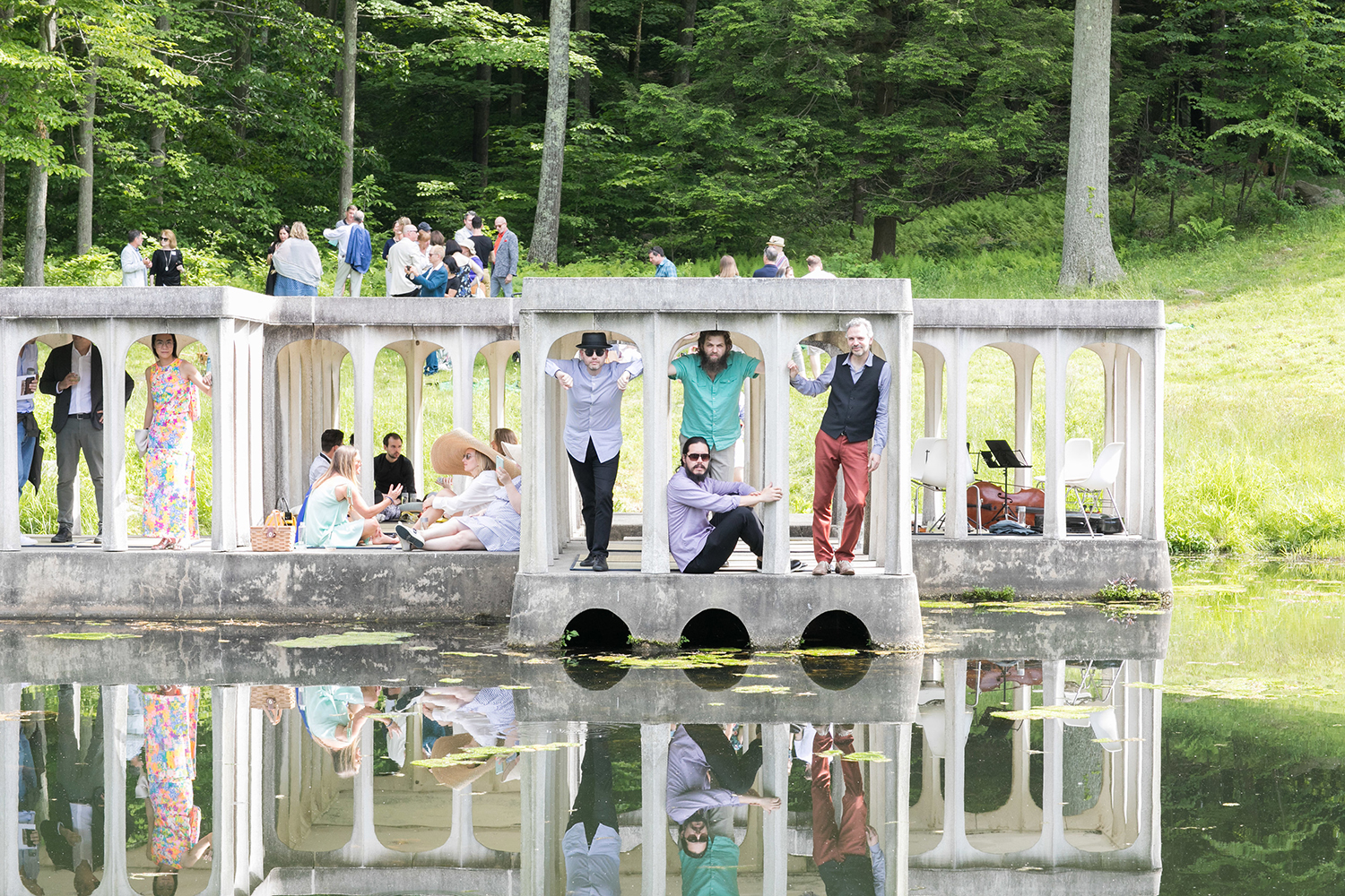 Photo of people hanging out in a pavilion on the grounds of the Glass House