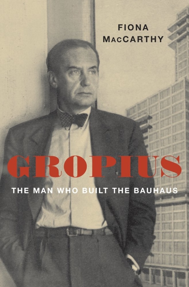 A man leaning against a wall, with the text "Gropius" over his chest