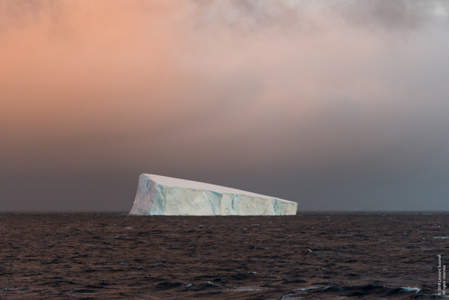 Photo of iceberg floating in the water