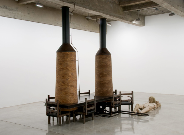 Photo of art installation of two cylindrical towers with chairs around them