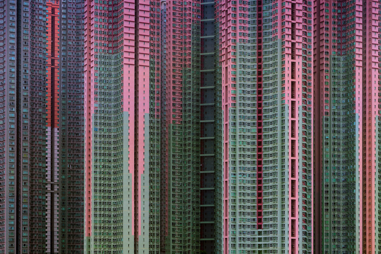 Photo of a wall of pink and neon green buildings with no sky