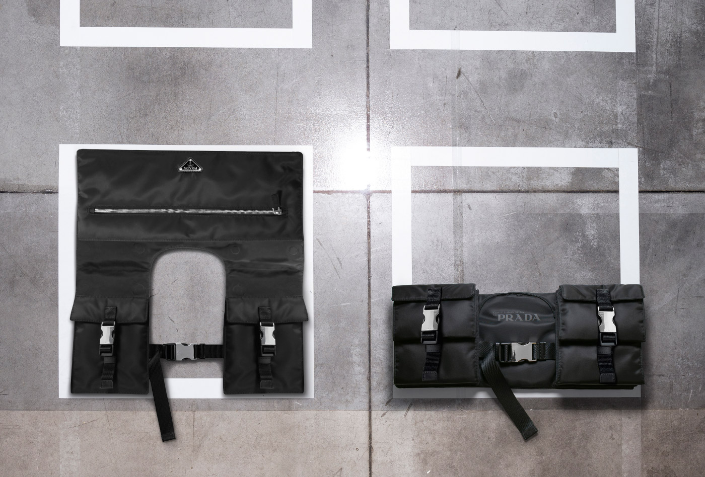 Photo of two black nylon bags on a concrete floor