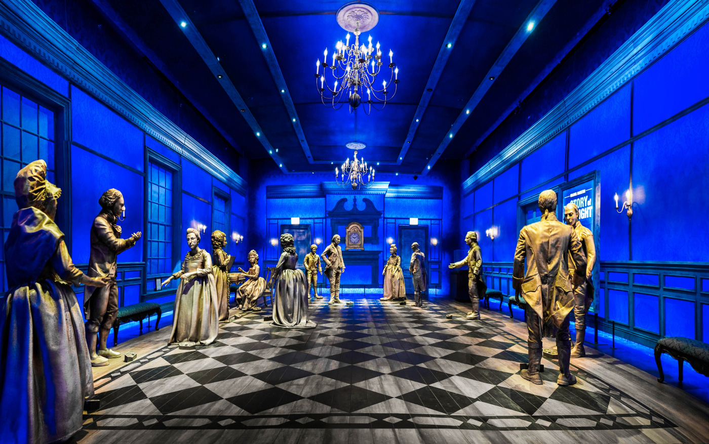 Photo of a blue ballroom with checkered floors and mannequins