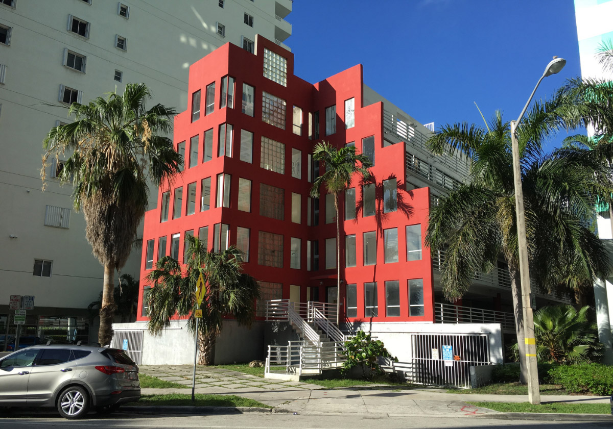 Photo of the Arquitectonica-designed Babylon, a 5-story, red, terraced apartment complex