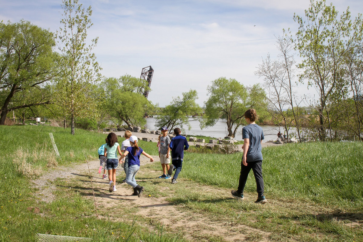 Photo of children running on grassy trail along river in the current DL&W Corridor