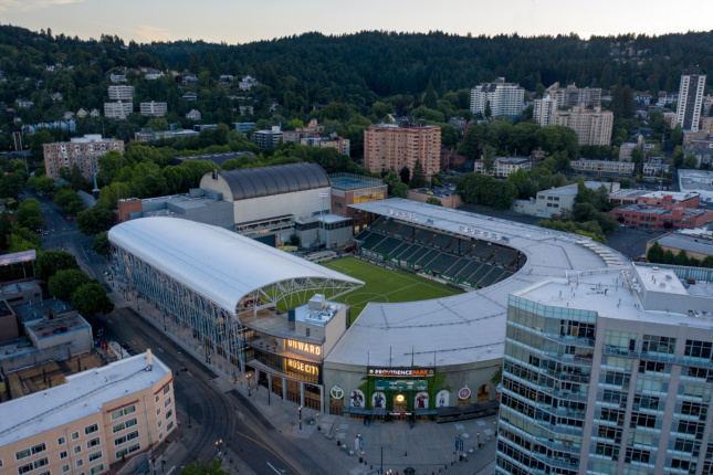 Aerial photo of a stadium with a curved extension at one side