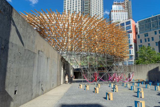 A circular pavilion covered in wooden planks supported by scaffolding, the winning entry to this year's Young Architects Program