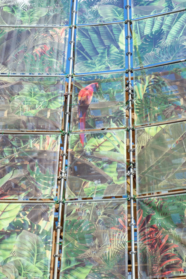 Close-up view of a textile adorned with jungle plants and monkeys