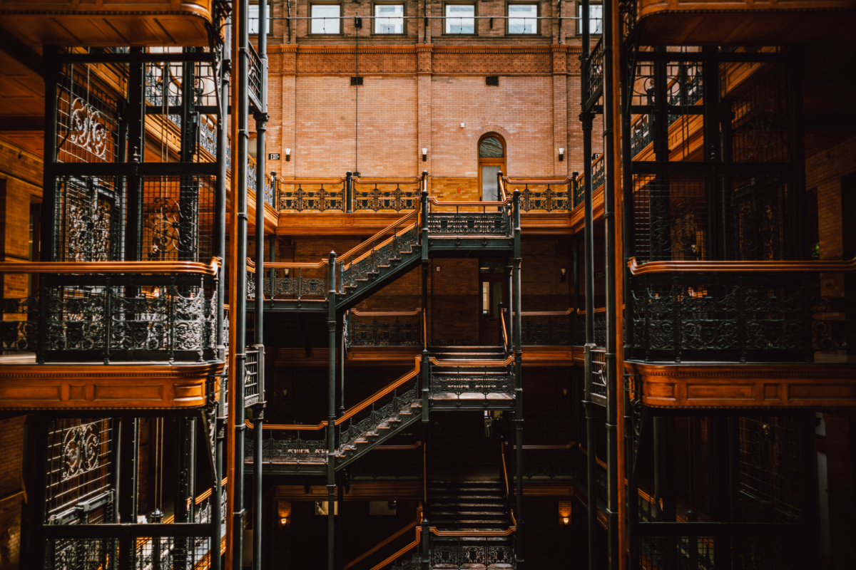 Interior photo of brick building with staircases covered in black wrought iron, inside the Bradbury Building