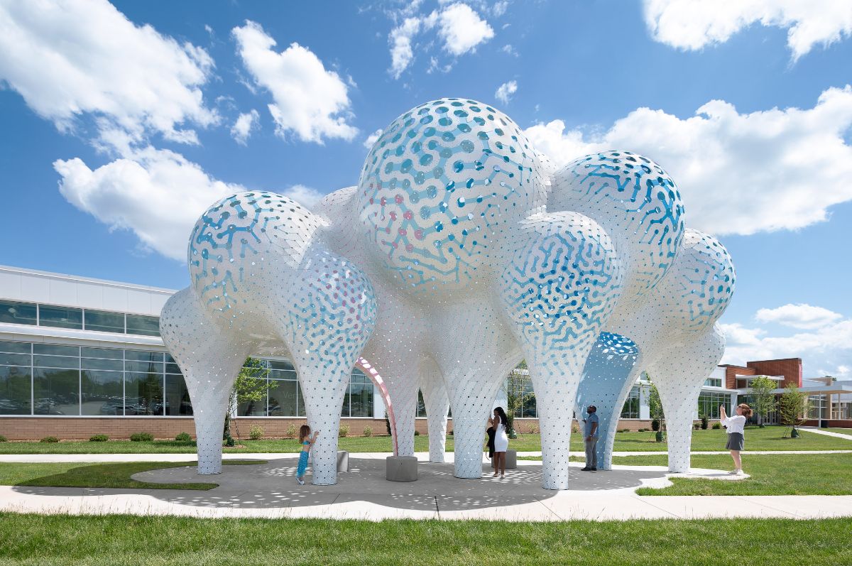 Photo of blue and white pavilion with pillars curving out into spheres