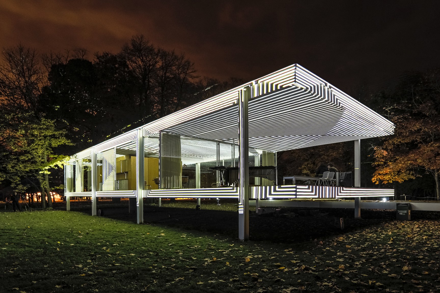 The Farnsworth House projected in black-and-white stripes at night