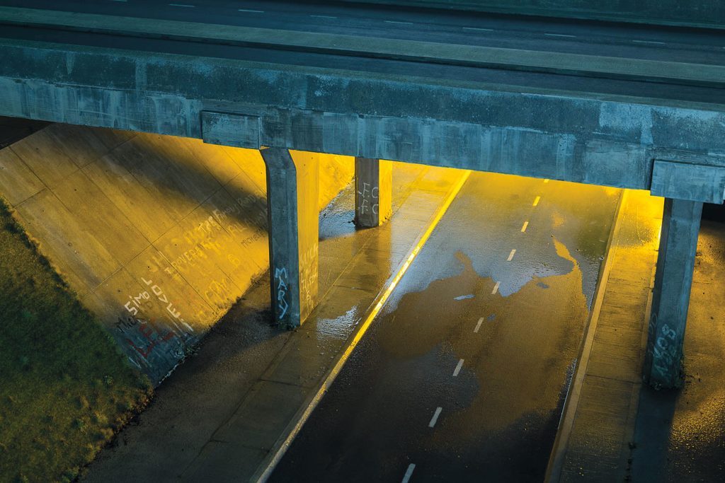 An overpass with yellow light beneath it, from M53, film still by Mark Leckey