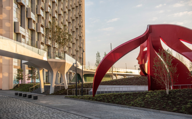Photo of red sculpture next to elevated park