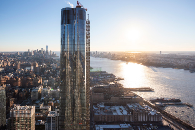 A glass tower rising on the Hudson River