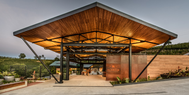 A Starbucks on an open hilltop with a large wooden canopy and open walls