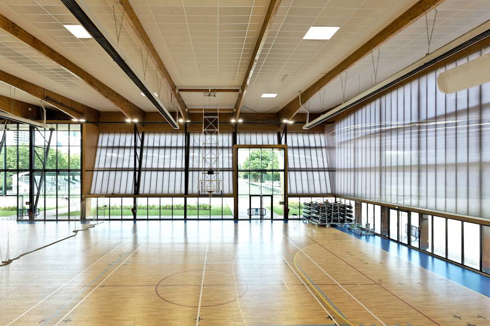 The interior of a gymnasium with large swing-out windows