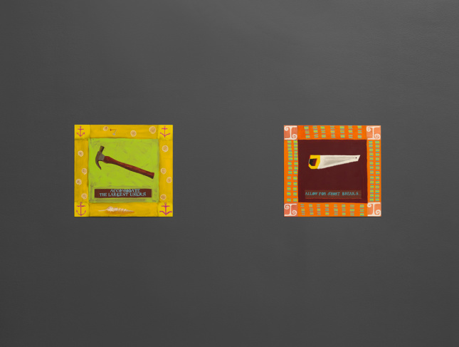 Two small square images on the wall at the New Museum, one of a hammer and the other of a saw