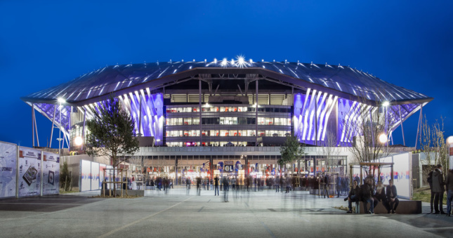 Night shot of stadium lit up with purple lights