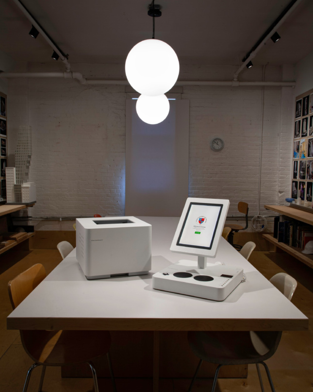 A sleek printer and tablet attached to a voting pad