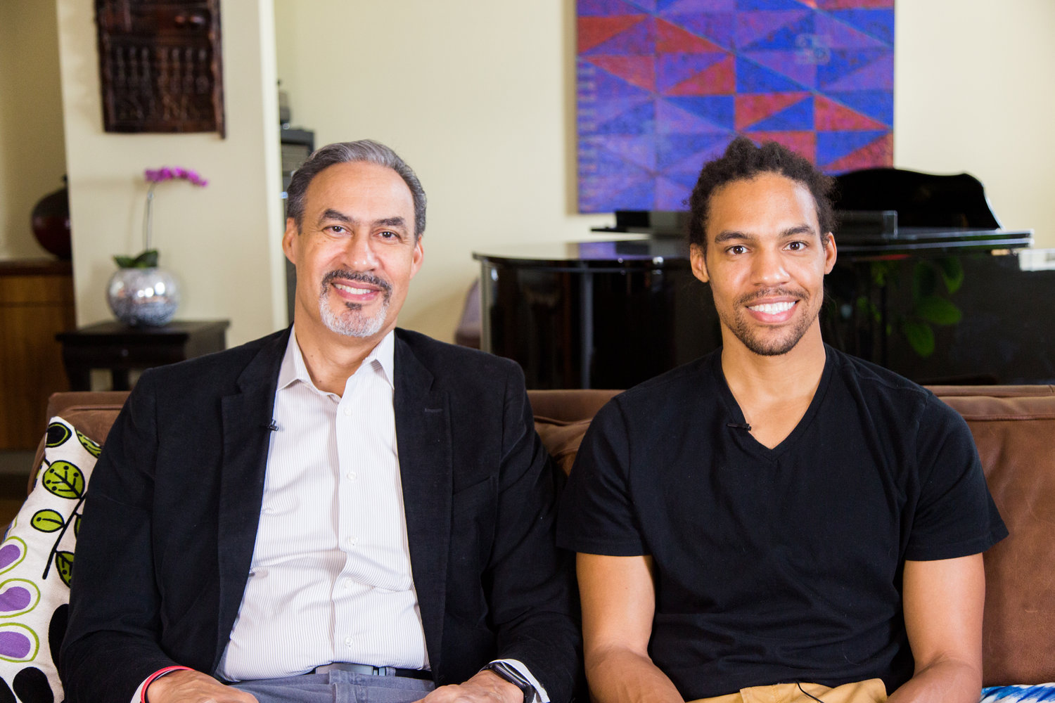 Two African American men seated next to each other, one of whom is Phil Freelon