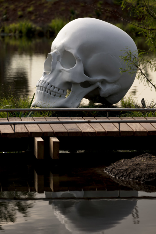 A giant skull alongside a river walk