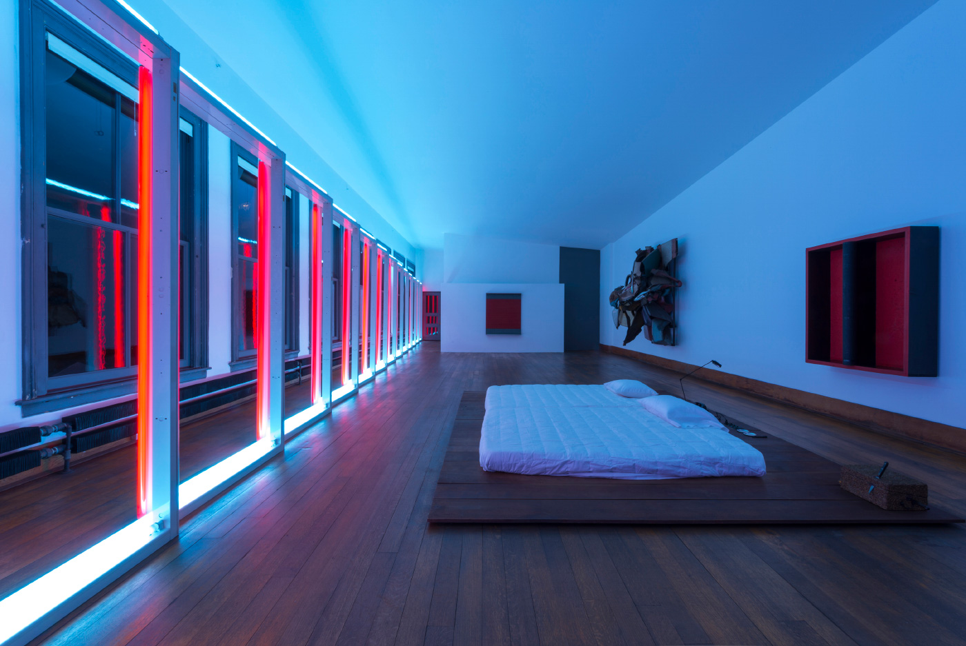 Interior of the Donald Judd Foundation home in New York, a blue and pink-lit bedroom