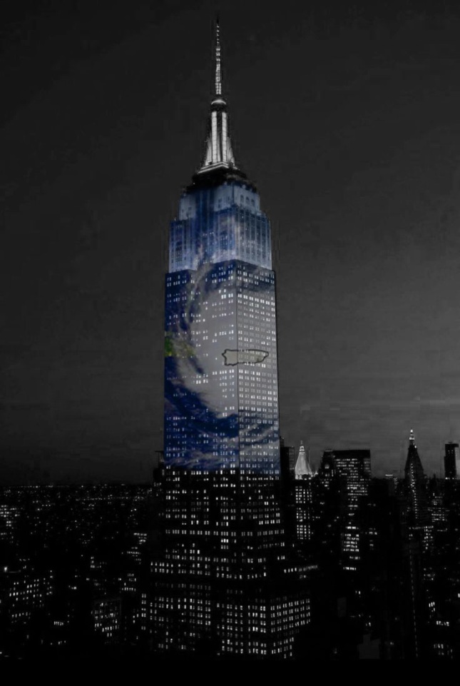 Photomontage of World Trade Center with Hurricane Maria eye illuminated on facade