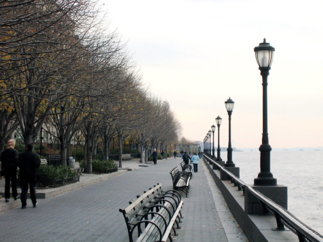 View of Battery Park Esplanade with lamps, benches, and trees