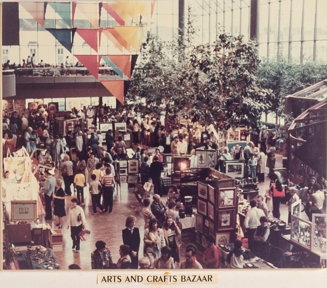 People gathered inside of a mall for a crafts fair