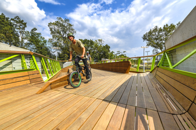 Image of biker of wooden bridge with green steel rails