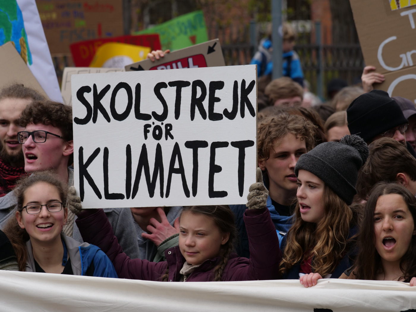 Greta Thunberg holding a sign advocating for climate action, in anticipation of the Global Climate Strike