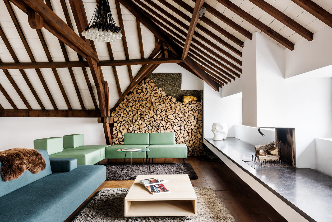 Interior of a white loft with exposed timber beams, the new home of Lensvelt