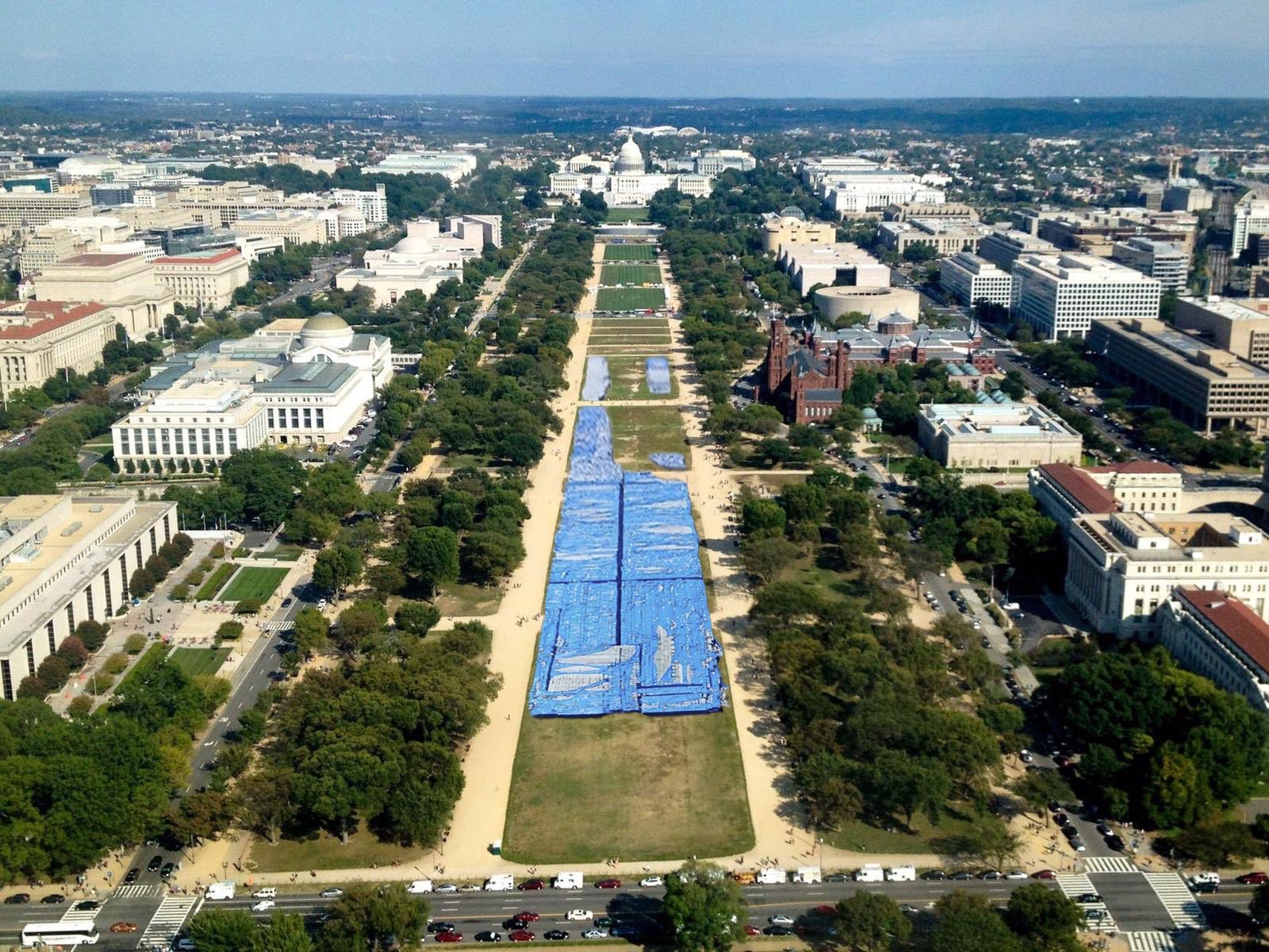 Photomontage of aerial view of National Mall with tarps laid on lawn