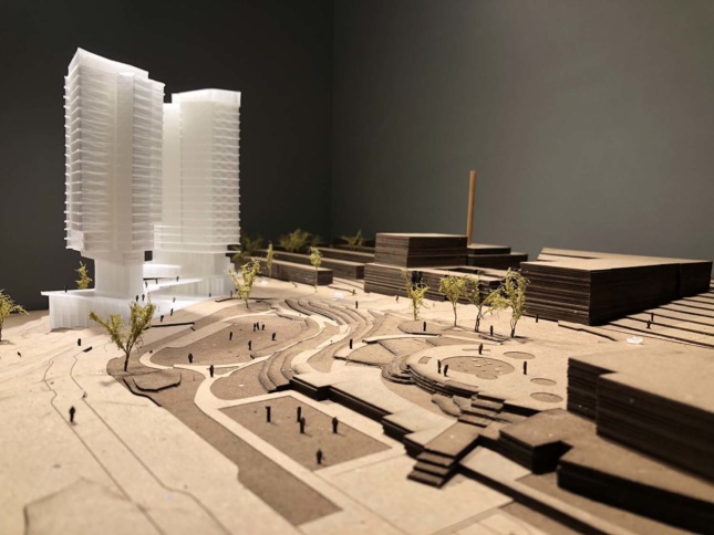 Model of a white tower in a cardboard landscape, presented by the Seattle Architecture Foundation