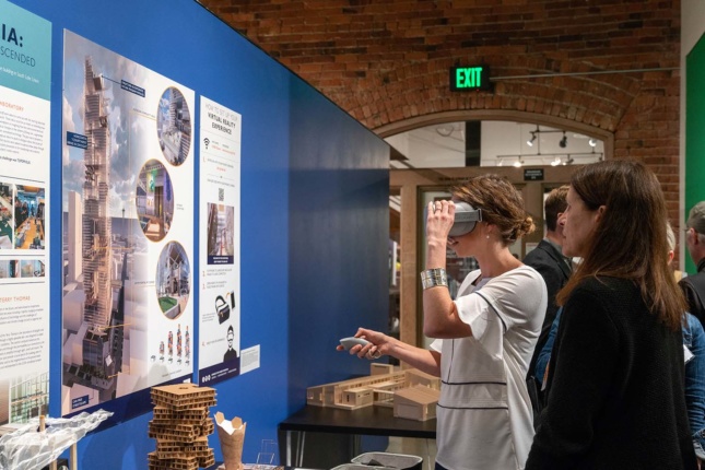 A woman looking into a VR headset at the Seattle Architecture Foundation
