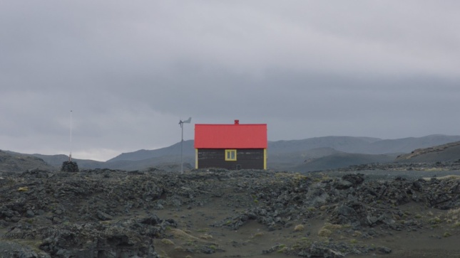Photo of a house with red roof in an empty landscape