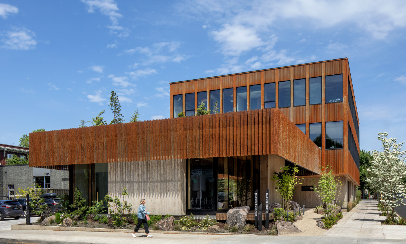 Photo of a low-slung building wrapped with vertical timber louvers, The Nature’s Conservancy's new headquarters