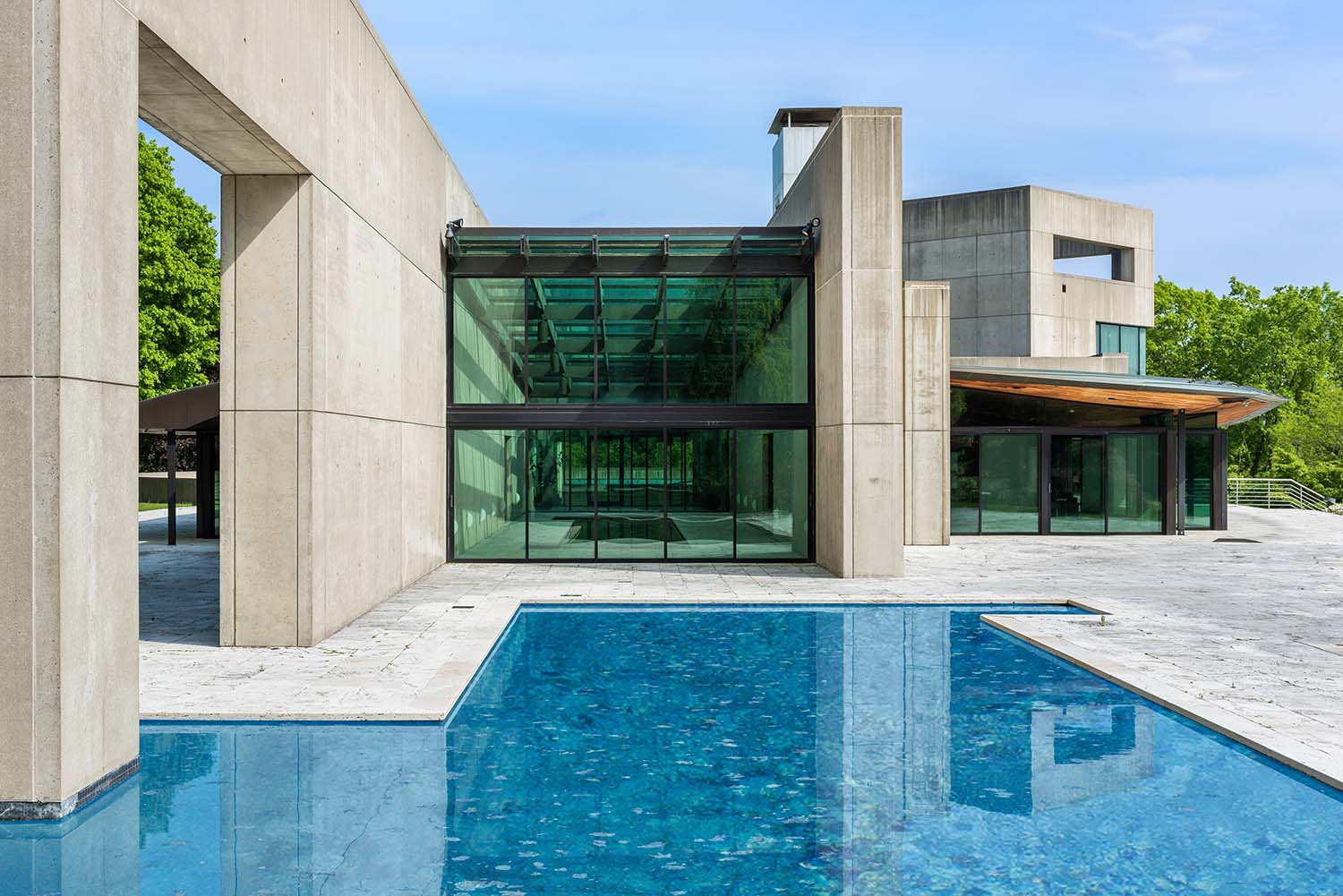 A house designed by Rafael Viñoly with stark concrete walls and a pool