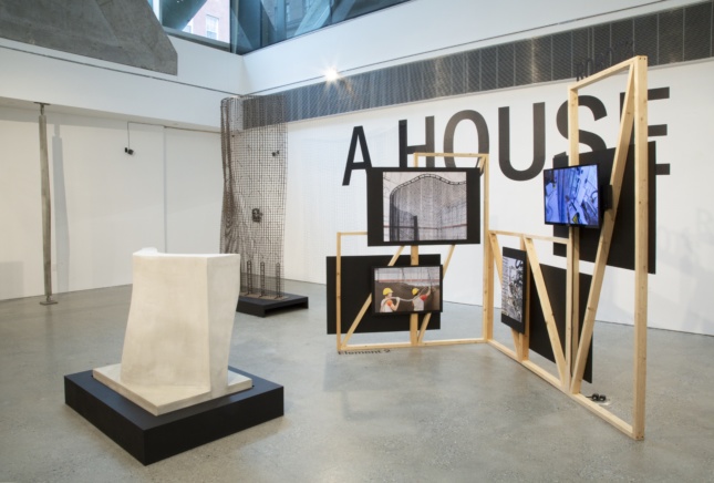 Timber frame against the words "A House," part of a digital fabrication show