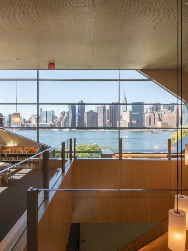 Inside Hunters Point Library, showing the Manhattan skyline