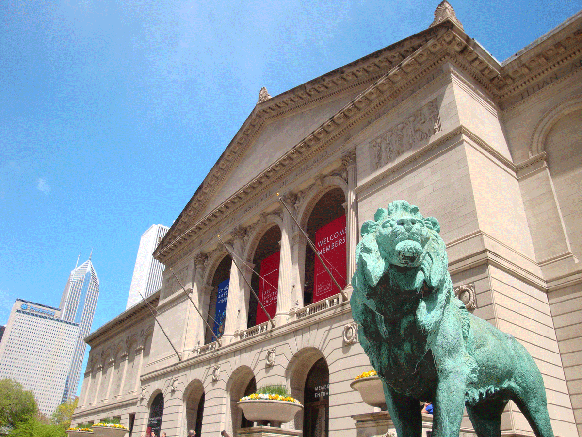 Image of museum entrance with lion statue on top of steps