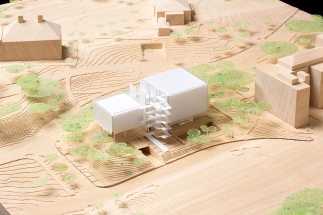 Model on a cardboard background of the new Agora Institute, with two square volumes