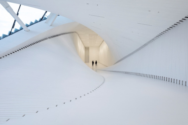 A curving, white gallery space in the twist