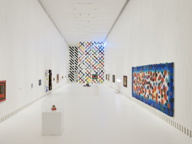 A white, double-height gallery space