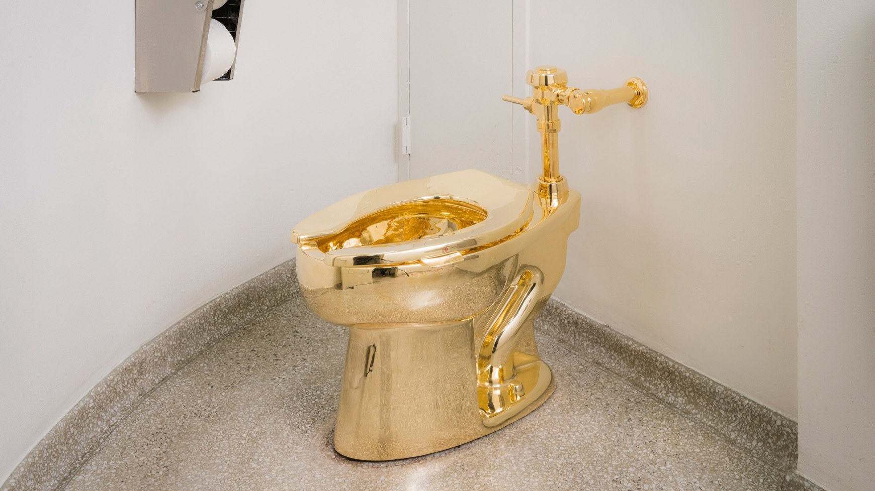Photo of a solid gold toilet, a sculpture titled 