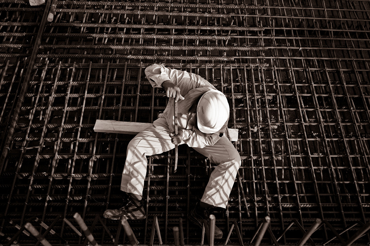 Aerial image of construction worker sitting on steel beams